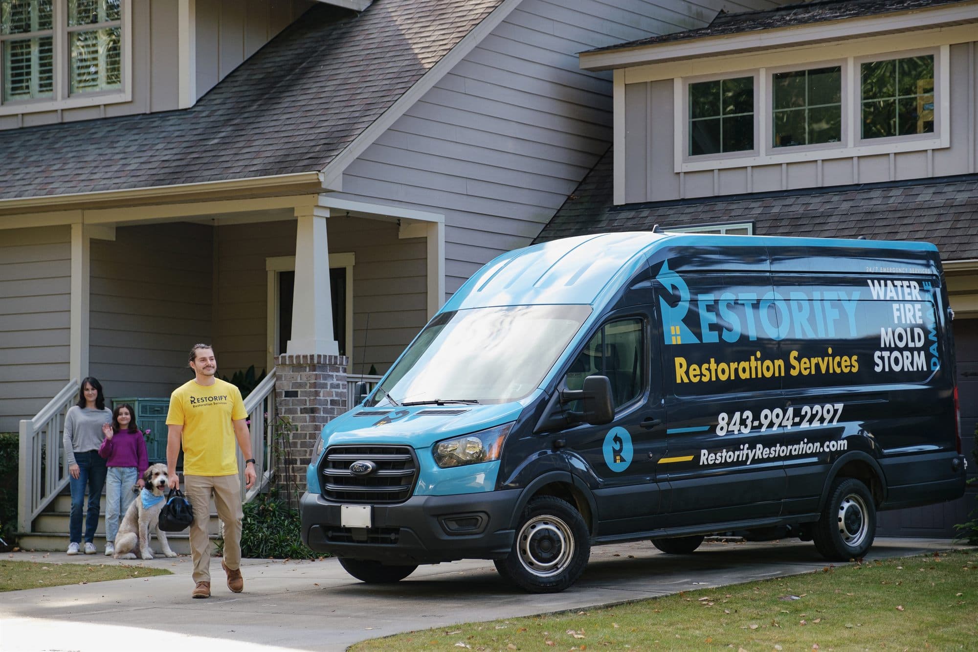 Restorify Restoration technician and branded van arriving at a Charleston family's home