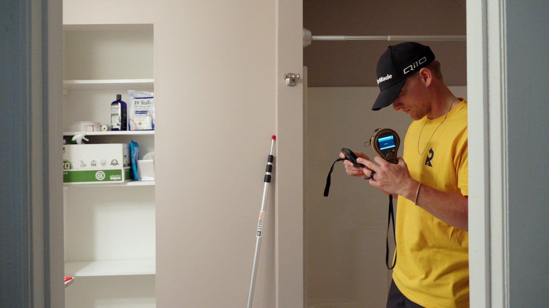 Restorify technician taking a moisture reading during a home inspection
