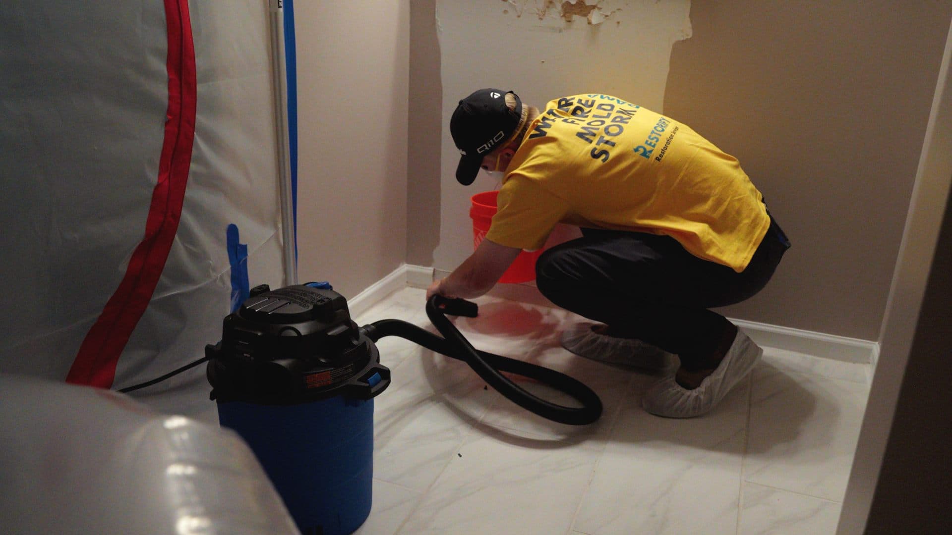 Restorify technician extracting water from a flooded floor